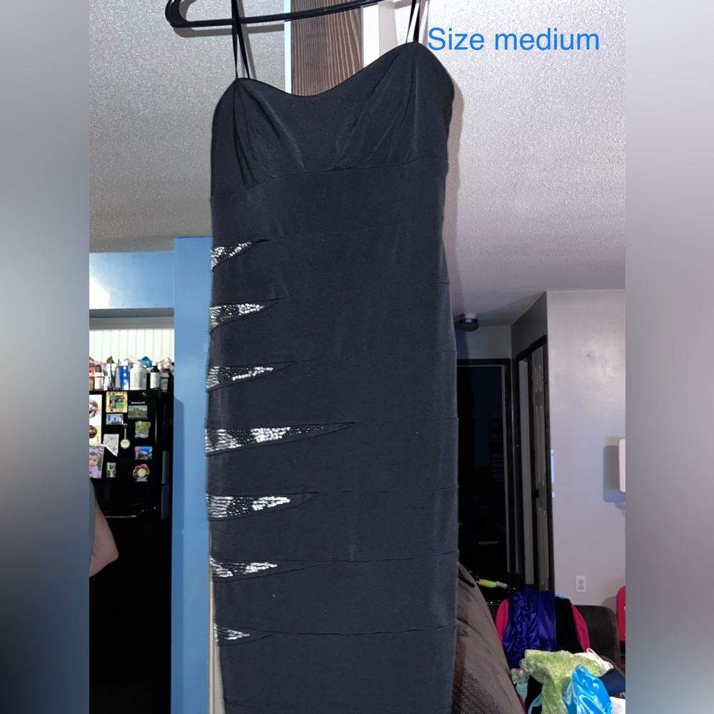 Black dress with metallic beading. Form fitting dress.